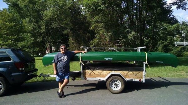 4 place canoe/kayak trailer with man and green canoe
