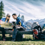 Couple looking at map on their fall camping trip